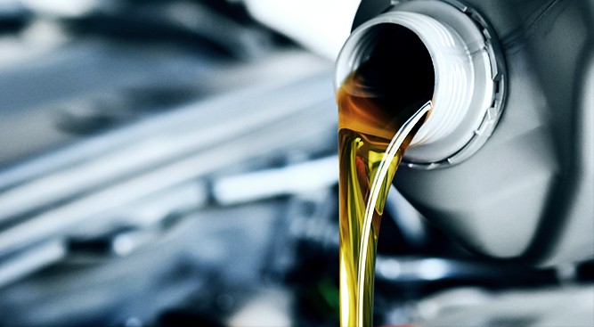 Oil-Pouring-Into-Engine