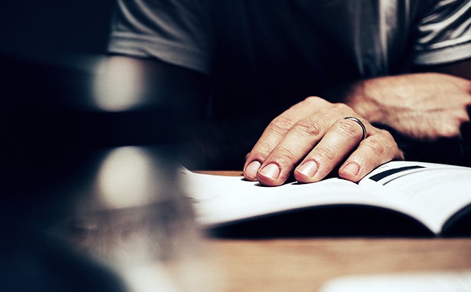 Man-Reading-Car-Owner's-Manual