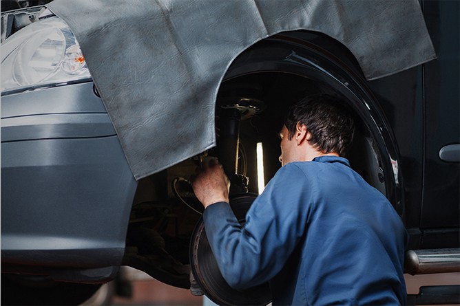 Mechanic-Inspecting-Car-Suspension