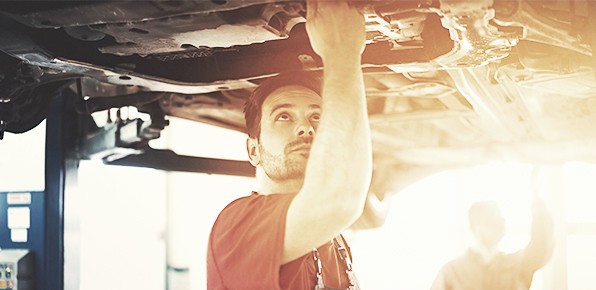 Mechanic-Examining-Car-Undercarriage