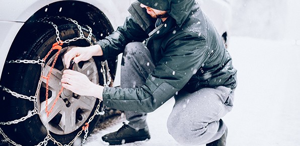 Driver-Putting-Chains-On-Tire