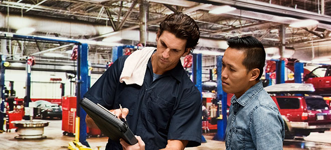 Mechanic-showing-customer-car-part-options