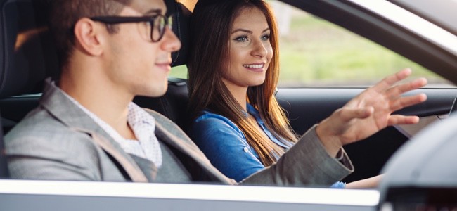 Man-And-Woman-Riding-In-Car
